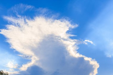 Stunning fluffy cloud formation against bright blue sky. clipart