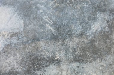 Soyut gri ve mavi desenli beton duvar yüzeyi.