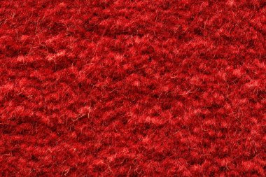 Yumuşak liflerle dolu zengin kırmızı desenli yün kumaş arkaplanı.