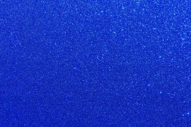 Bir sürü küçük mavi noktalı mavi bir arka plan..