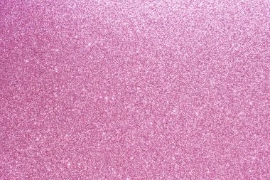 Ortasında pembe ve beyaz bir nesne olan pembe parıltılı arka plan. Arka plan çok parlak ve parlak. Eğlenceli ve eğlenceli bir atmosfer izlenimi veriyor.