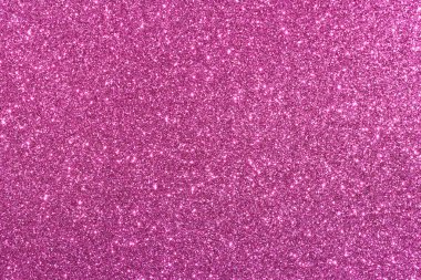 Pembe bir arka plan ve parlak bir doku. Arka plan pembe ve simler de pembe. Işıltı arka fonun her tarafına saçılmış. Parlak ve parlak bir görüntü veriyor.