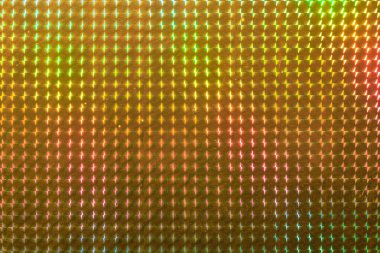 Renkli, parlak ve yansıtıcı bir yüzey. Kare şeklinde. Yüzey yansıtıcı ve parlak bir maddeden yapılmış gibi görünüyor ve karelerden oluşan bir deseni var.