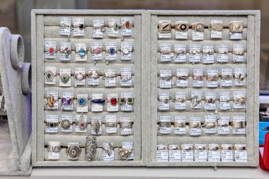 Vintage jewelry display in gray case with assorted rings and brooches. November 3, 2023 Balti Moldova.