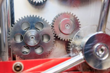 Close-up of interlocking metal gears in a mechanical device. clipart