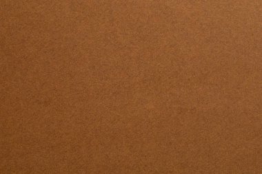 Bir sürü deseni olan kahverengi bir arka plan. Doku pürüzlü ve kumlu. Arkaplan, görüntünün ana odak noktasıdır, desenli origami kağıt arkaplanı