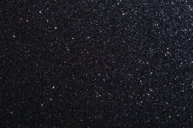 Simli siyah bir arka plan. Parıltı tüm arka plana saçılmış.