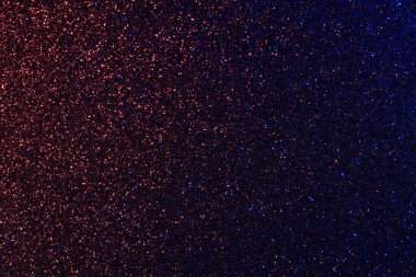 Parıltılı mavi ve kırmızı bir arka plan. Parıltı farklı boyutlarda ve her yere saçılmış.