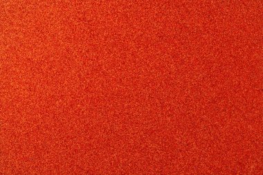 Canlı turuncu bir arka plan ve etrafa saçılmış sayısız küçük turuncu noktalar. Turuncu arka plan ve noktalar canlı ve enerjik bir atmosfer yaratıyor.