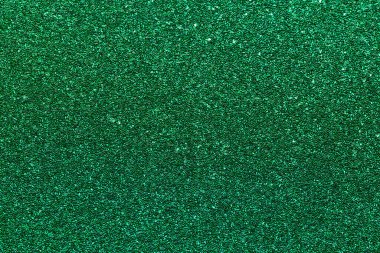 Bir sürü küçük yeşil noktalı yeşil bir arka plan. Arka plan çok parlak ve canlı. Noktalar arka fonun her yerine dağılmış, hareket ve enerji hissi yaratıyor.