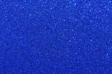 Parıltılı mavi bir arka plan. Parıltı mavi ve ışığı yansıtıyor gibi görünüyor.