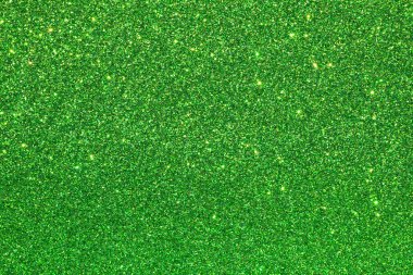 Işıltılı bir dokusu olan canlı yeşil bir arka plan. Parıltı parlak yeşil bir renk ve o parlak ve yansıtıcı. Genel etki canlı ve göz alıcı bir sahne.