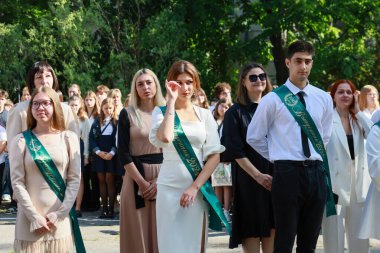 Bir grup Kafkas mezunu genç dışarıda mezuniyeti kutluyor. 31 Mayıs 2024 Balti Moldova.