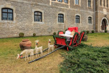 Red sleigh with a reindeer on it. December 15, 2024 Busteni Romania. clipart