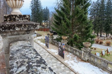 Stone wall with a white vase on top. December 15, 2024 Busteni Romania. clipart