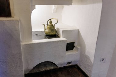 Çaydanlık, Drakula Kalesi 'ndeki küçük bir ocak üzerinde duruyor. 16 Aralık 2024 Bran Romanya.