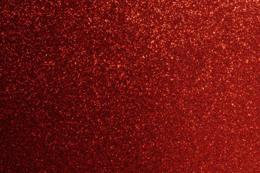 Kırmızı arkaplanda bir sürü kırmızı parıltı var. Arka plan kırmızının derin bir gölgesidir, ve parıltı görüntü boyunca dağılır, bir hareket ve enerji hissi yaratır.