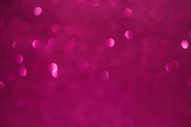 Bir sürü küçük daireli pembe bir arka plan. Çemberler bulanık ve örtüşüyor.