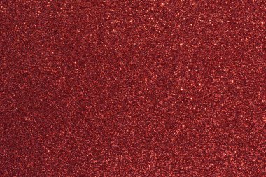 Kırmızı arkaplanda bir sürü kırmızı parıltı var. Arka plan kırmızının derin bir gölgesidir, ve parıltı görüntü boyunca dağılır, bir hareket ve enerji hissi yaratır.