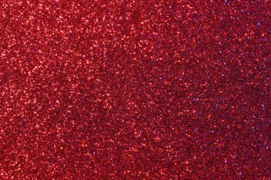 Kırmızı simli kırmızı bir arkaplan. Parıltı tüm arka plana saçılmış.