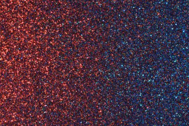 Parıltılı mavi ve kırmızı bir arka plan. Parıltı farklı renklerde ve her yere saçılmış.