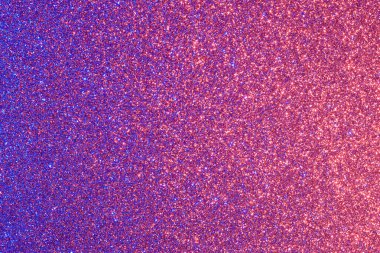 Pırıl pırıl parlayan mor ve mavi bir arka plan. Parıltı farklı renklerde ve her yere saçılmış.