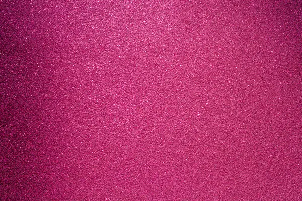 Pembe bir arka plan ve bir sürü parıltı. Parıltı farklı boyutlarda ve her yere saçılmış.