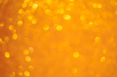 Küçük daireleri olan sarı bir arka plan. Çemberler bulanık ve örtüşüyor.