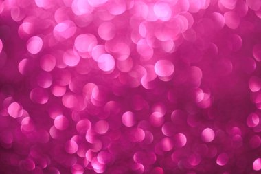 Pembe arka plan ve küçük pembe daireler. Daireler bulanık ve örtüşüyor, hareket ve enerji hissi yaratıyor. Sahne eğlenceli ve kaprisli.