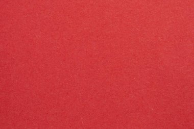 Ortasında beyaz bir nesne olan kırmızı bir arkaplan. Nesne, beyaz kenarlıklı, dokulu origami kağıt zeminli küçük bir kare.