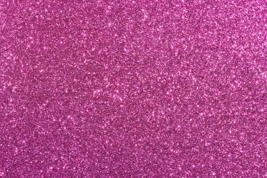 Pembe bir arka plan ve parlak bir doku. Arka plan pembe ve simler de pembe. Parıltı arka fonun her tarafına dağılmış, parlak ve parıltılı bir görünüm veriyor.