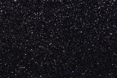 Simli siyah bir arka plan. Parıltı tüm arka plana saçılmış.