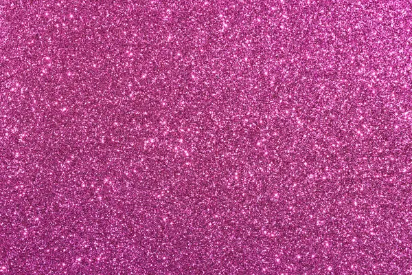 Pembe bir arka plan ve parlak bir doku. Arka plan pembe ve simler de pembe. Parıltı arka fonun her tarafına dağılmış, parlak ve parıltılı bir görünüm veriyor.