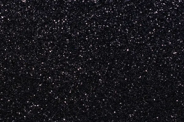 Simli siyah bir arka plan. Parıltı tüm arka plana saçılmış.