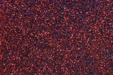 Kırmızı ve mavi ışıltılı bir arka plan. Renkleri parlak ve dokusu pürüzlü.
