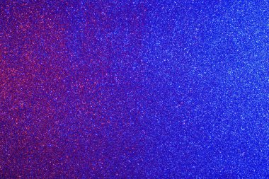 Çok sayıda küçük, dağınık noktalı canlı bir mavi ve kırmızı arkaplan. Arkaplan renkleri, çeşitli boyutlarda olan noktalara karşı çarpıcı bir karşıtlık oluşturur