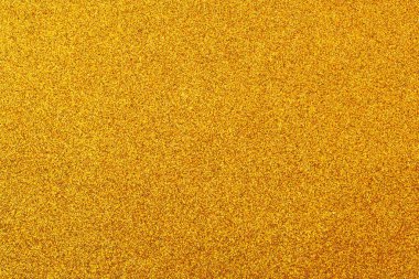 Bir sürü küçük sarı noktalı altın bir arka plan. Arka plan parlak ve noktalar her yere dağılmış.