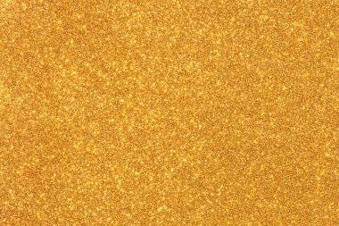 Işıltılı desenli altın bir arka plan. Altın rengi parlak ve parlak, ve parıltı görüntüye bir hareket ve enerji hissi katıyor. Manzara canlı ve eğlenceli.