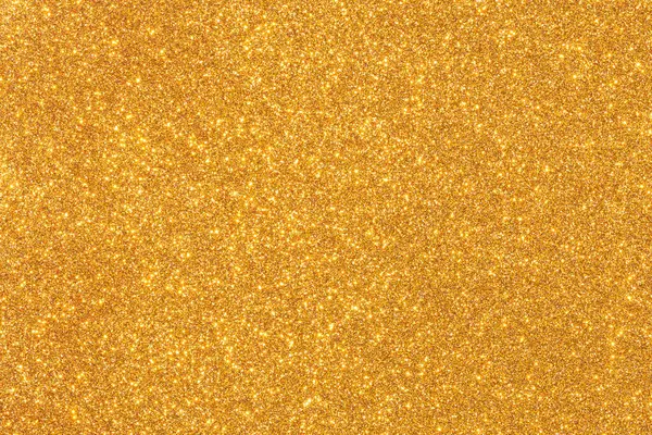 Işıltılı desenli altın bir arka plan. Altın rengi parlak ve parlak, ve parıltı görüntüye bir hareket ve enerji hissi katıyor. Manzara canlı ve eğlenceli.