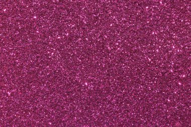 Parlak parçacıkların olduğu pembe bir arkaplan. Parıltı tüm arka plana saçılmış.