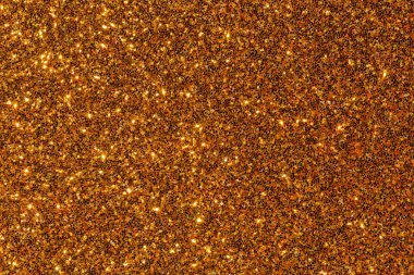 Altından ve ışıltılı bir arka plan ve bir sürü parıltı. Altın rengi görüntü boyunca baskın, sıcak ve lüks bir atmosfer yaratıyor. Parıltılar bir hareket hissi verir.