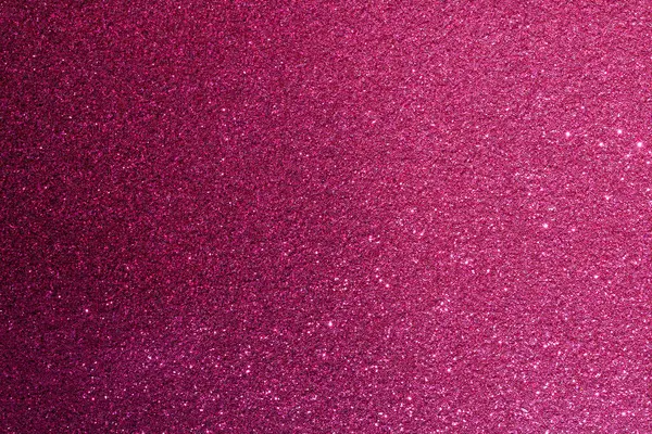 Pembe bir arka plan ve bir sürü parıltı. Parıltı farklı boyutlarda ve her yere saçılmış.