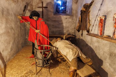 Kapüşonlu cellat ve zindandaki kurbanla ortaçağ işkence sahnesi. 18 Mart 2025, Madalyon, Çek Cumhuriyeti.