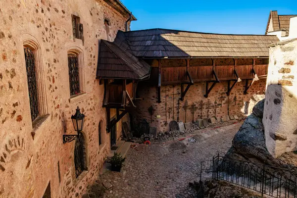 Ortaçağ kale avlusu. Açık bir günde taş duvarlar ve ahşap yapılar. 18 Mart 2025, Madalyon, Çek Cumhuriyeti.