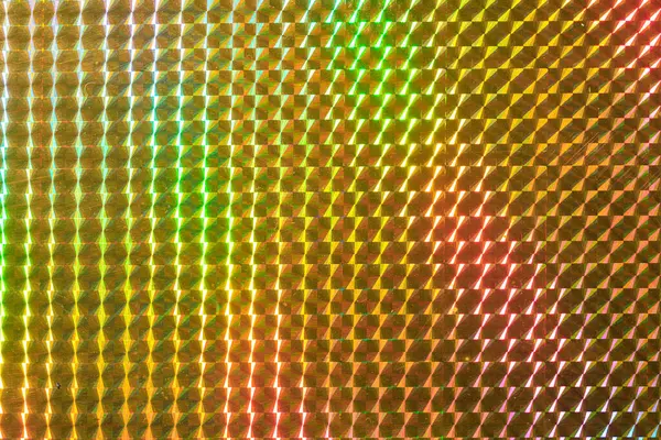 Renkli, soyut bir desen ve metalik bir parıltı. Renkler parlak ve canlı, enerji ve heyecan hissi yaratıyor. Kalıp küçük karelerden oluşuyor.