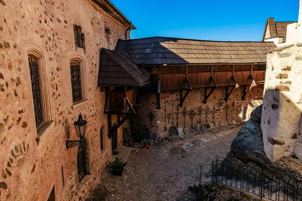 Temiz mavi gökyüzü altında kırsal mimarisi olan tarihi taş kale avlusu..