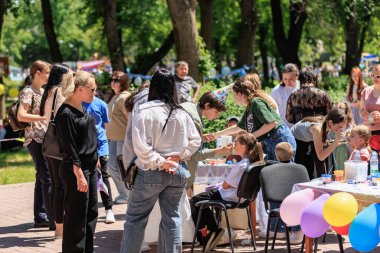 Açık hava çocukları aileleri ve park ortamında oyunlar ile parti veriyor. 22 Mayıs 2025 Balti Moldova.