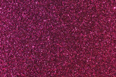 Pembe parlak bir arka plan yakın plan. Arka plan küçük, parlak, renkli sim parçalarından oluşuyor.