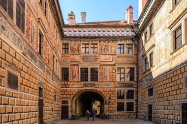 Karmaşık mimari detayları ve kemerli tarihi Avrupa avlusu. 20 Mart 2025, Cesky Krumlov, Çek.