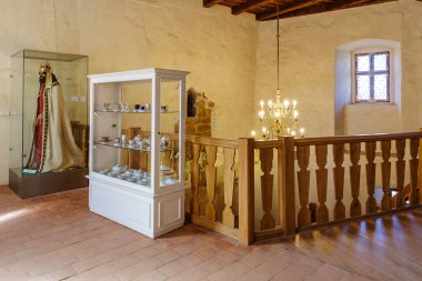 Sunlit müzesinde sergi çantası ve avizesi olan tarihi Avrupa iç mimarisi. 18 Mart 2025, Madalyon, Çek Cumhuriyeti.